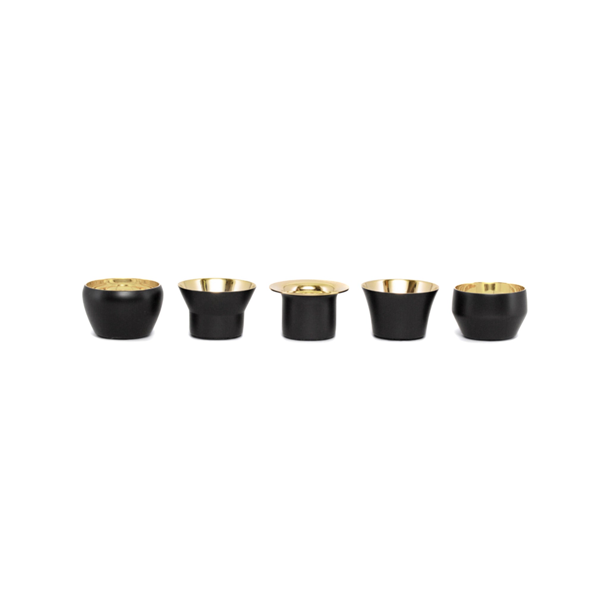a set of five black and gold tealights