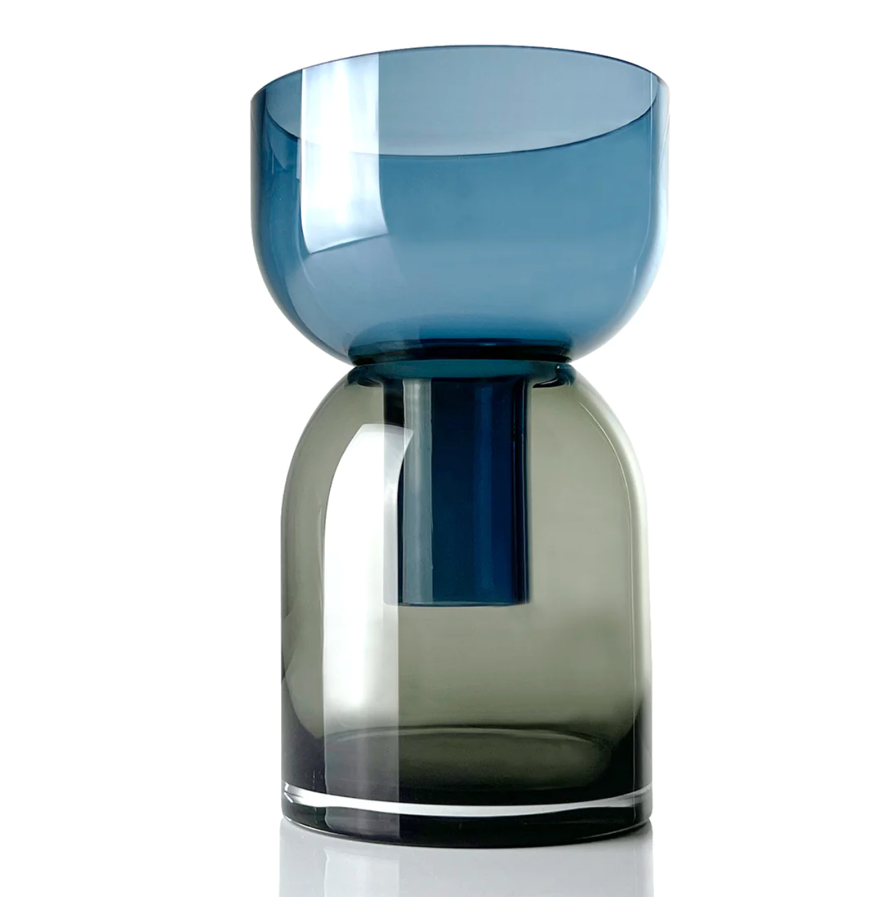 a blue and grey glass flip vase with the wide side up sitting on top of a white table