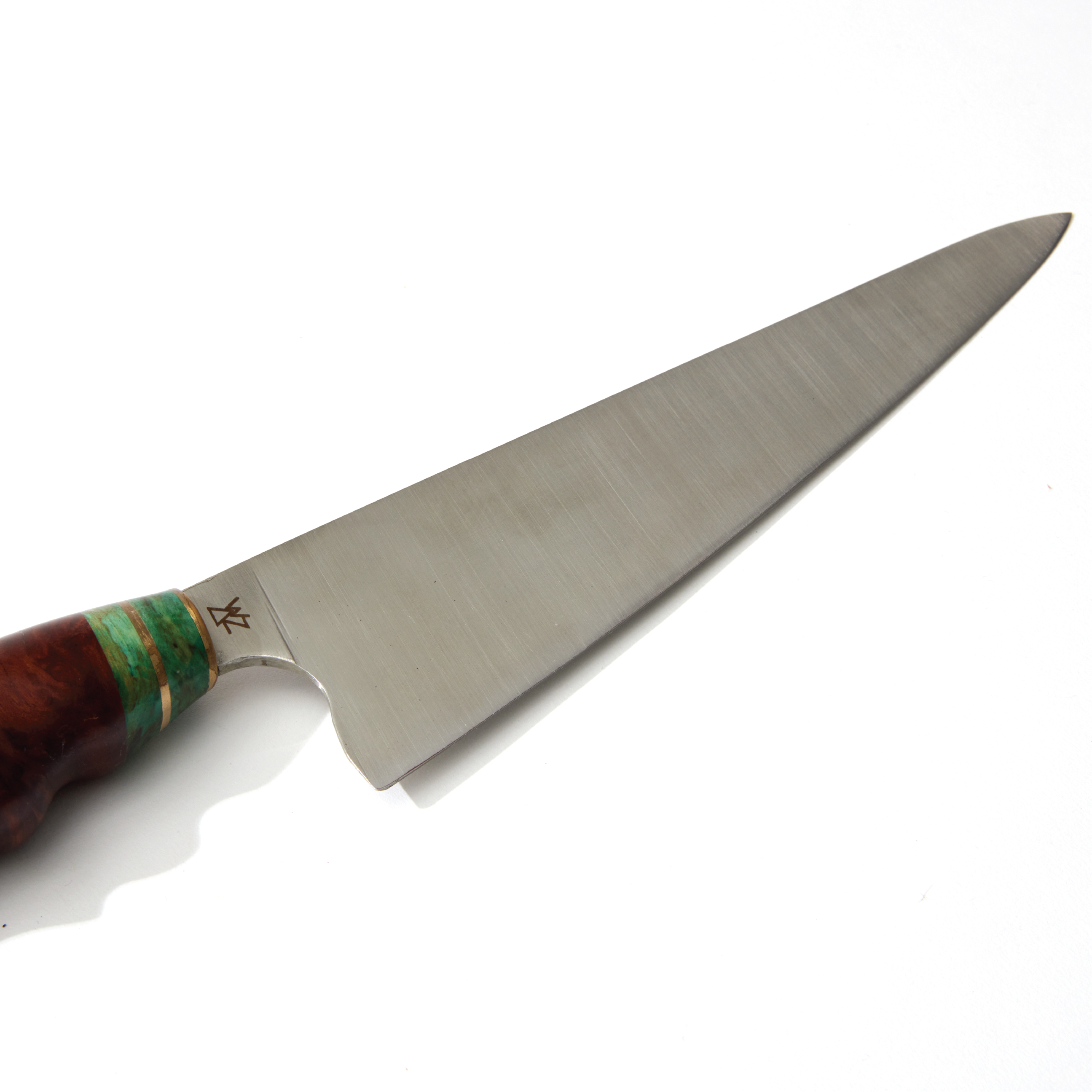 a large knife with a wooden handle on a white surface
