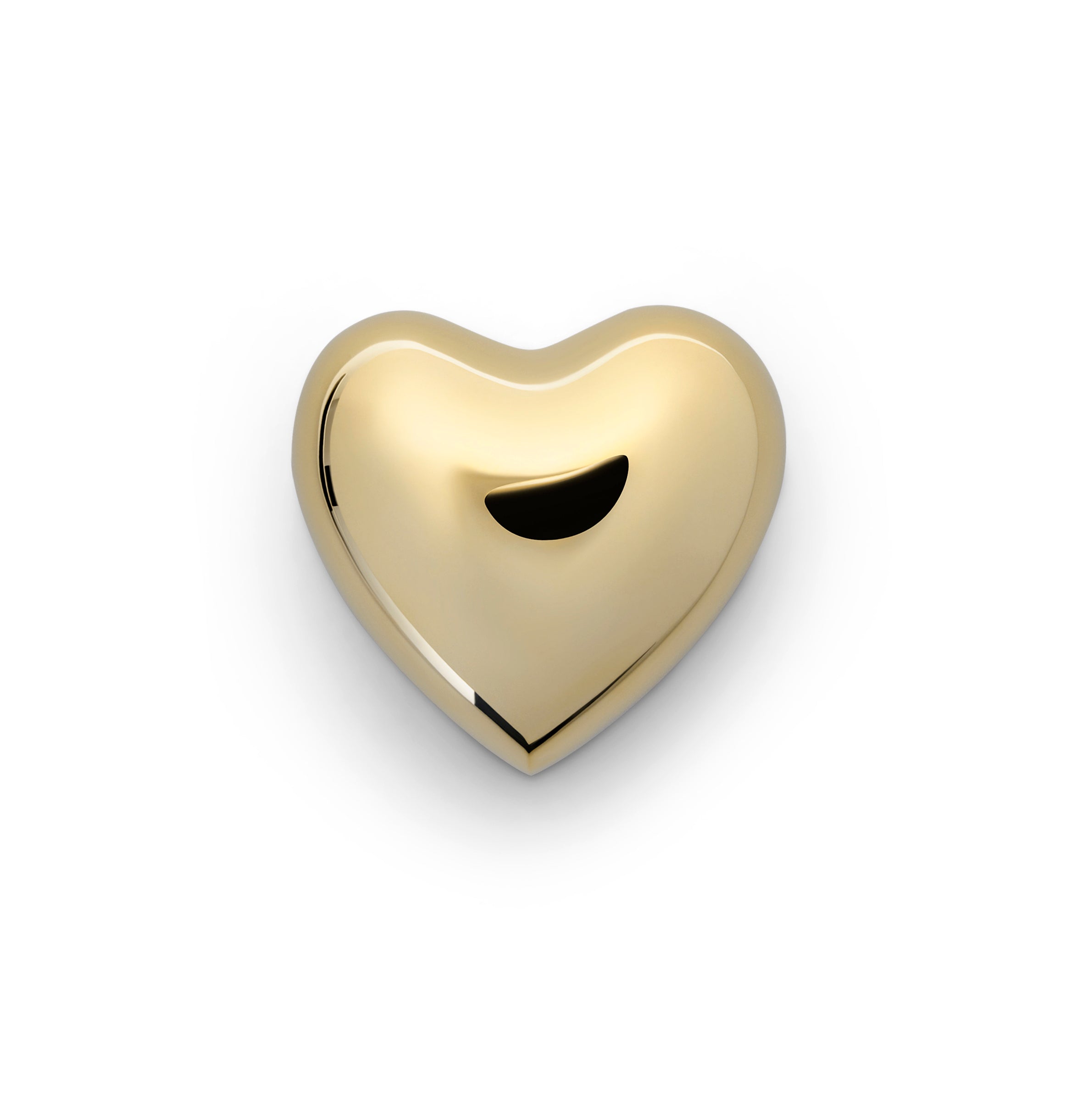 a brass heart shaped object on a white background