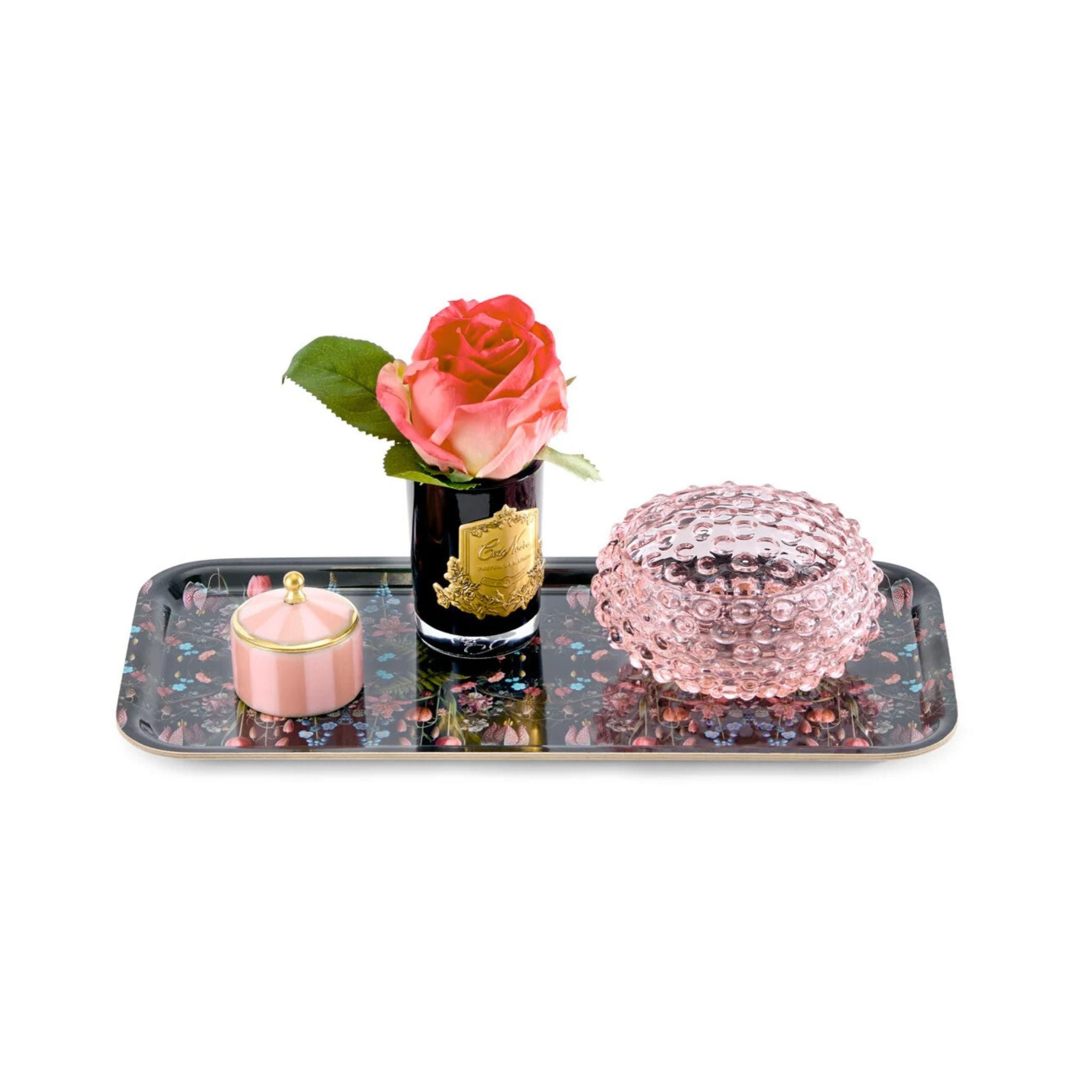 Decorative tray with a pink rose, candle, and decorative ball on a white background