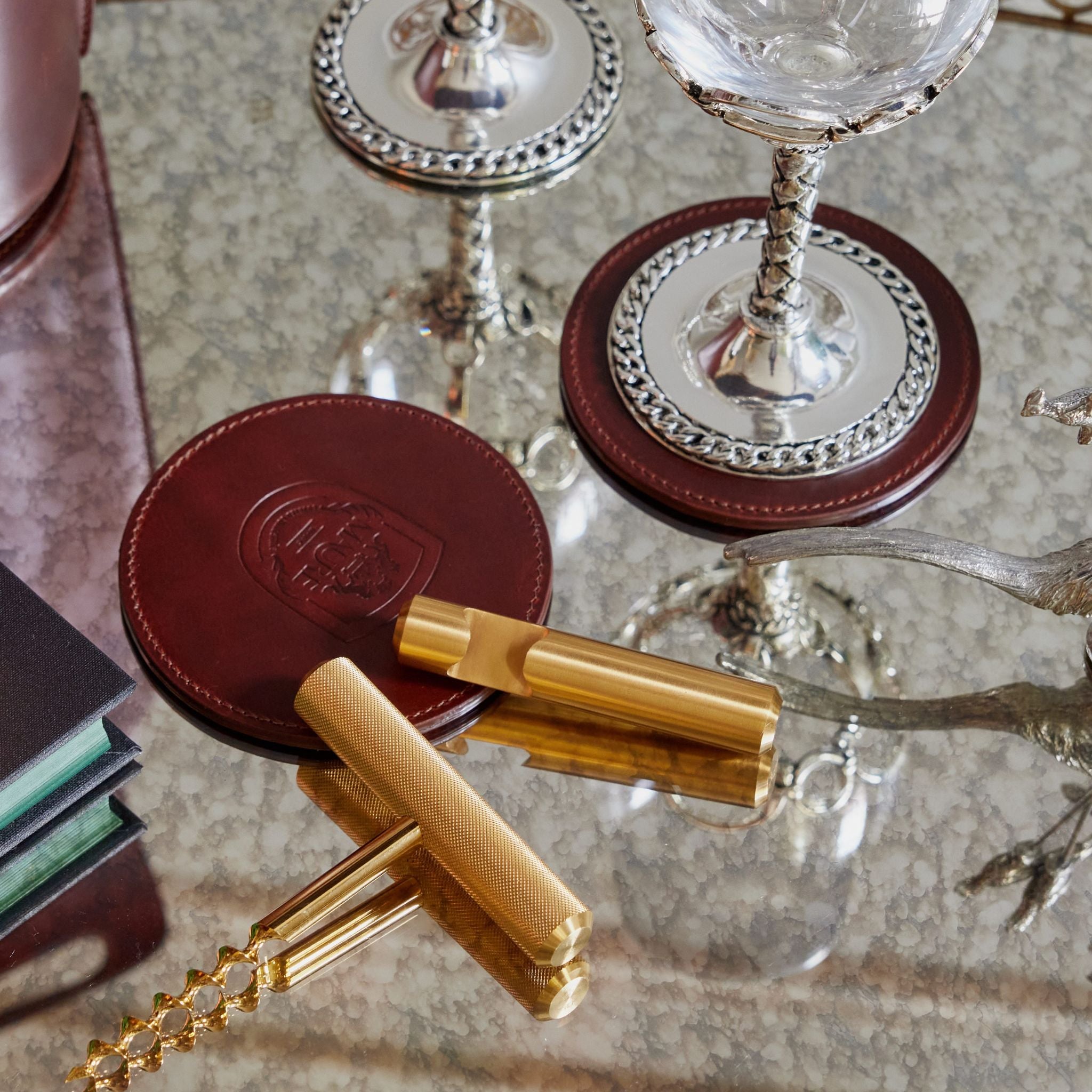 a close up of a table with a wine glass and coasters