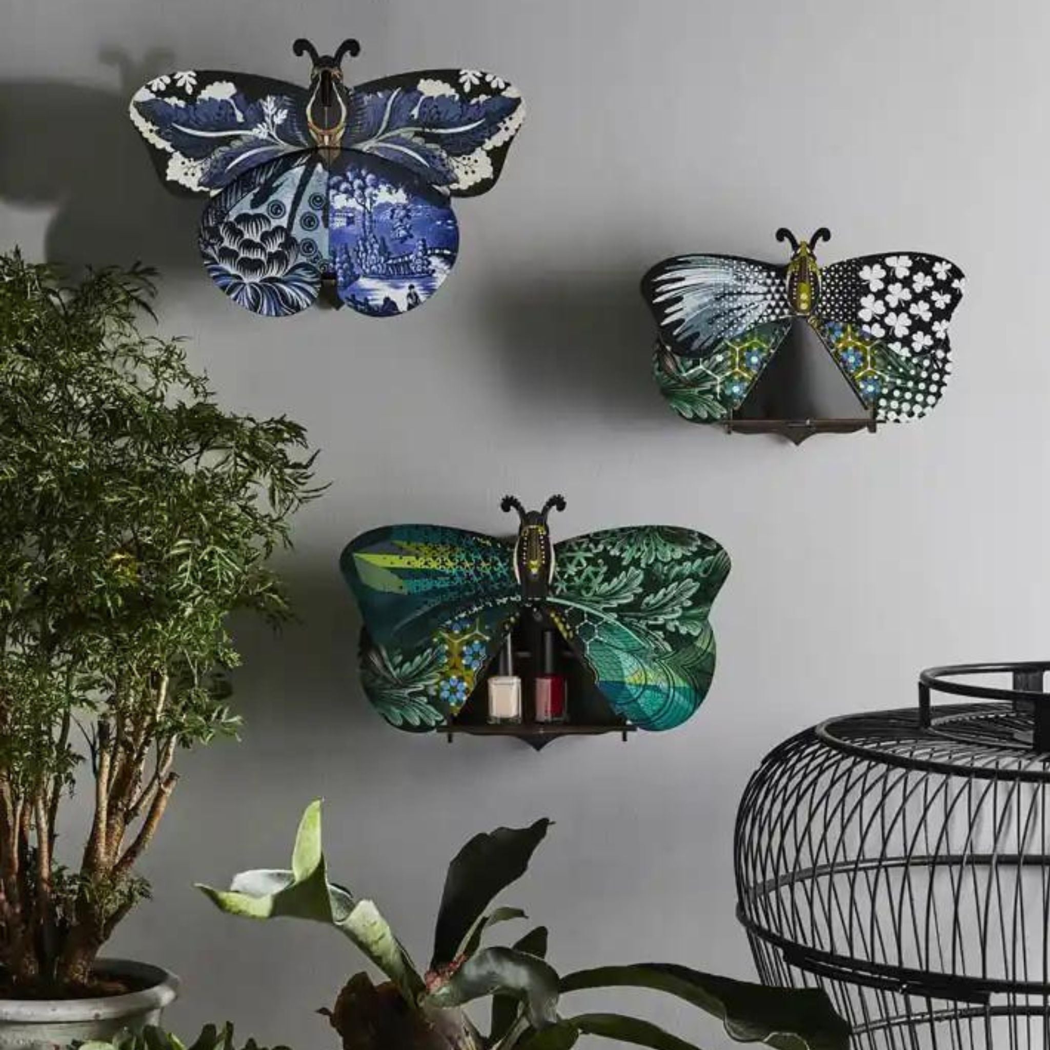 a bunch of butterfly storage boxes hanging on a wall