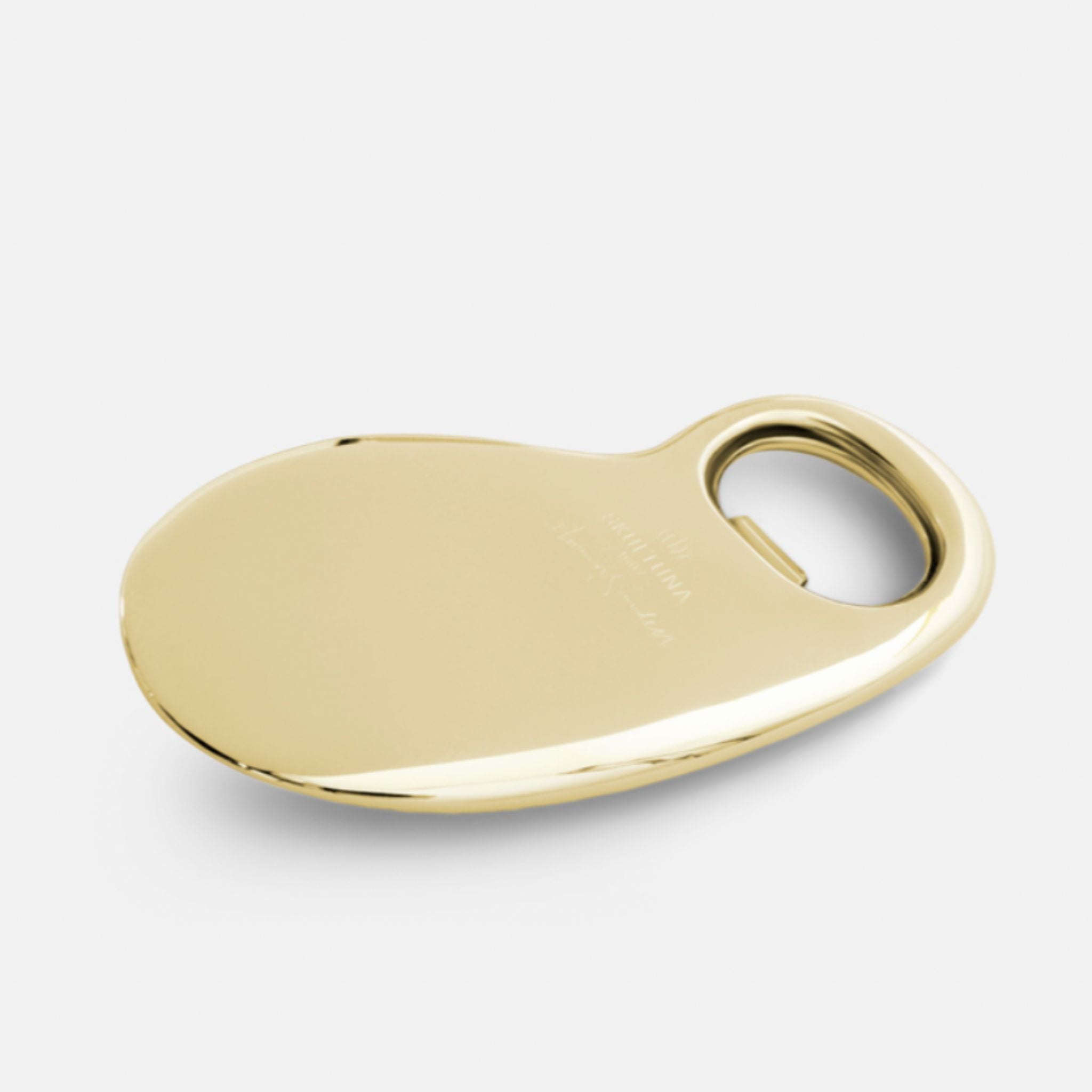 a gold bottle opener on a white background