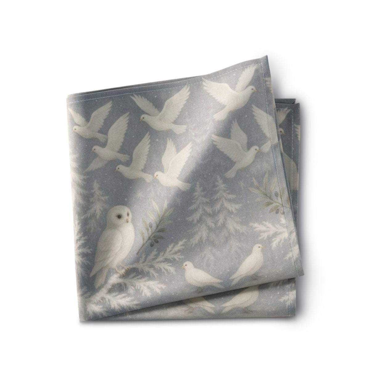 Folded fabric with bird and nature pattern on a white background