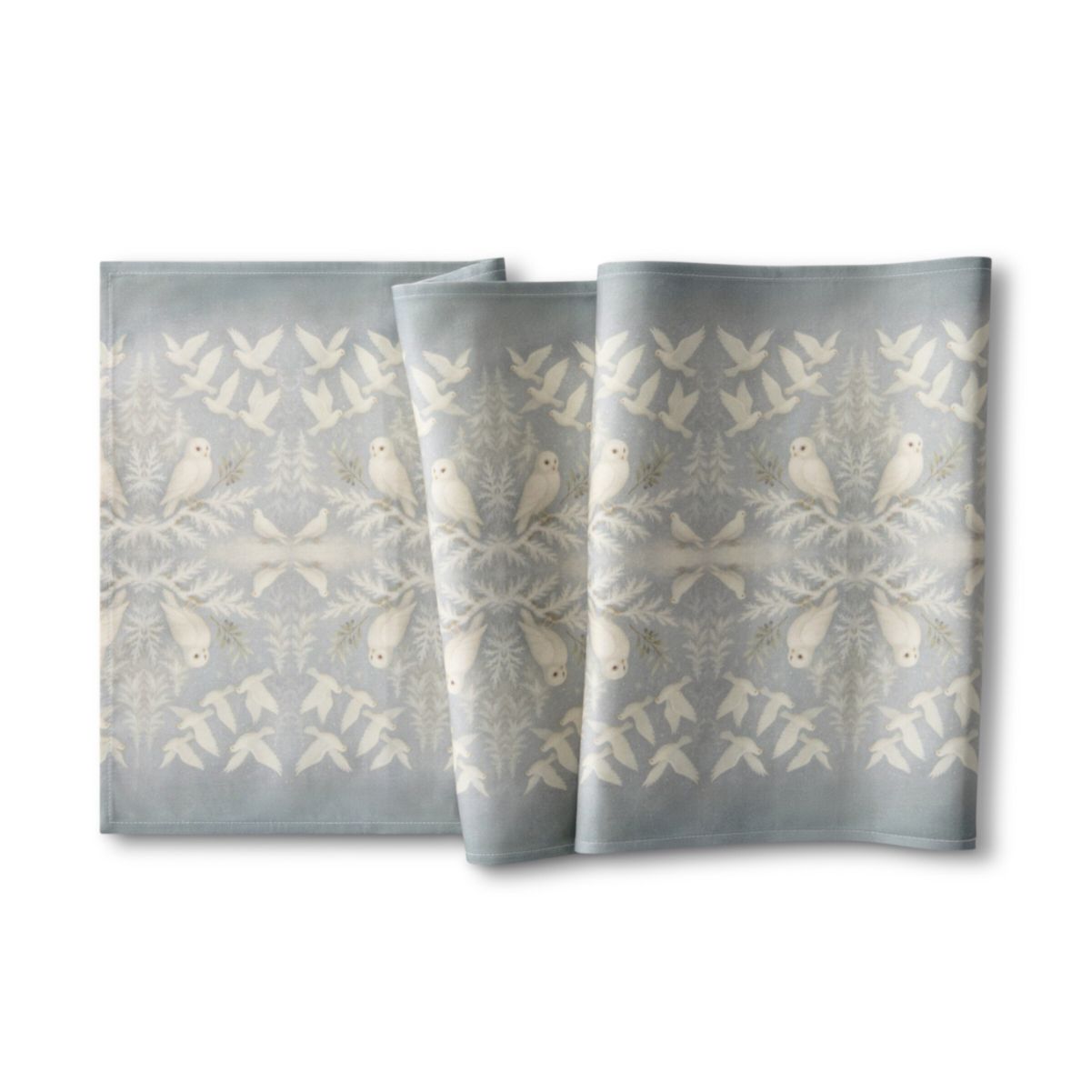 Set of three napkins with bird pattern on a white background