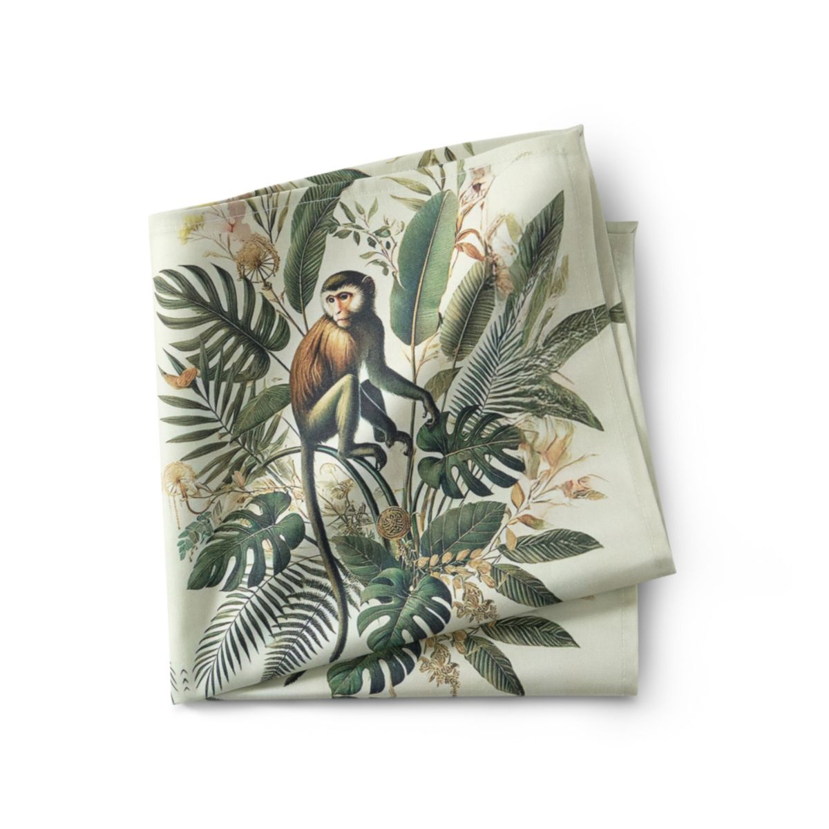 Folded fabric with a monkey and tropical leaf design on a white background