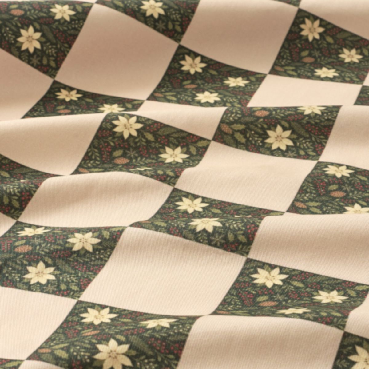 Checkered fabric with floral patterns on a green and beige background