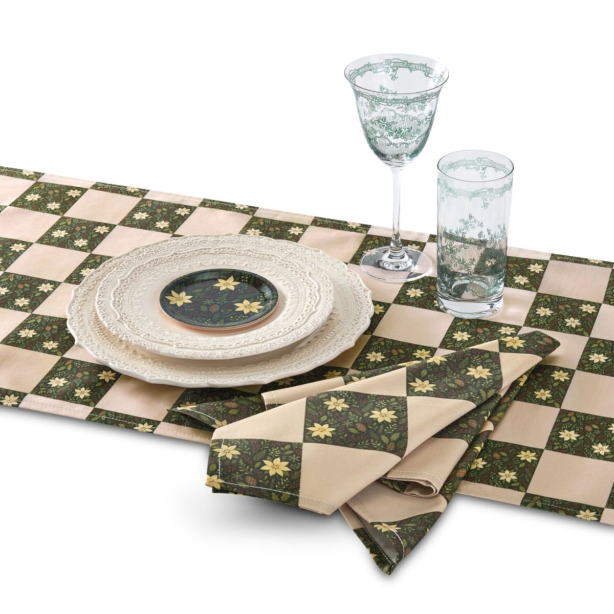 Table setting with green and beige checkered tablecloth, plates, and glasses on a white background