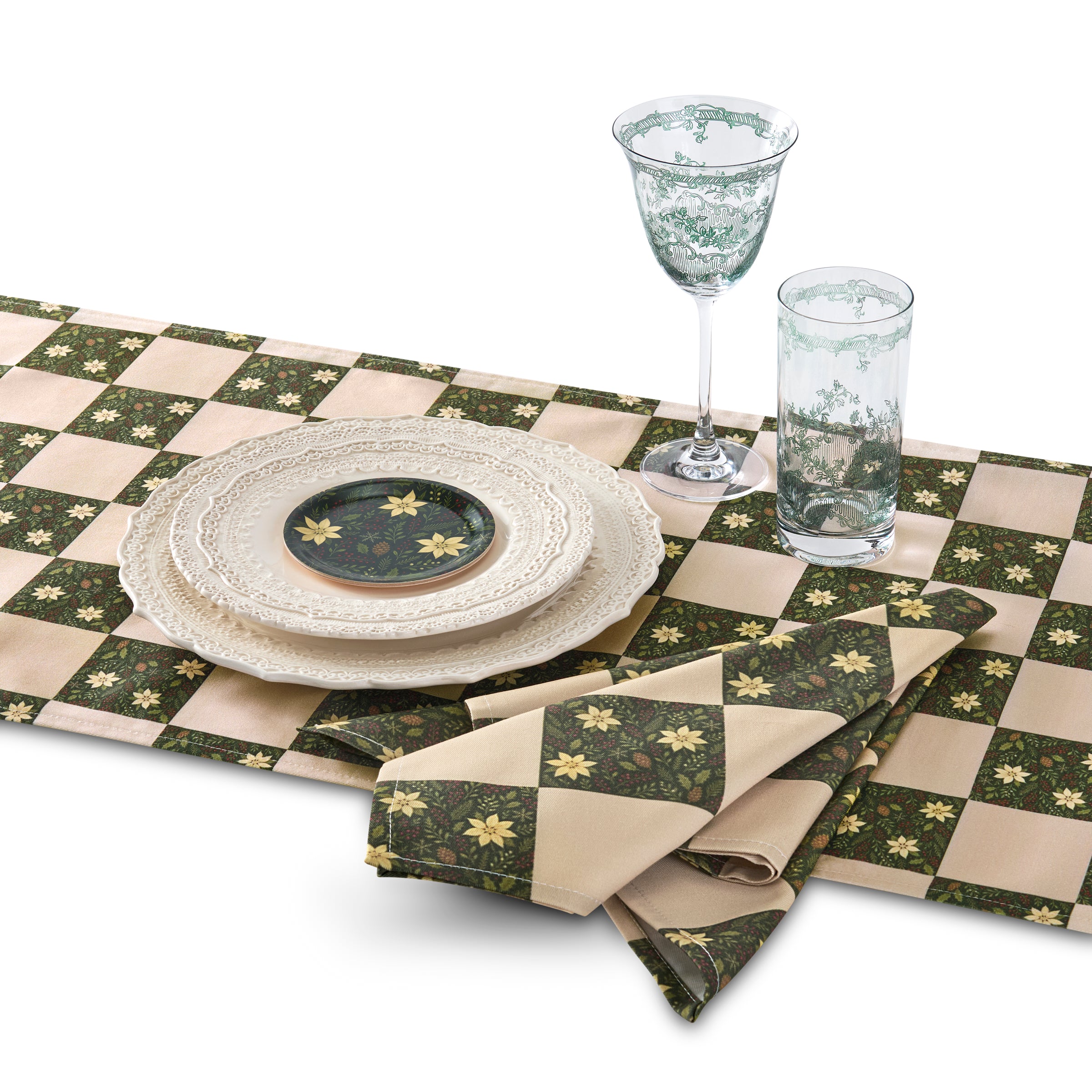 Table setting with a green and beige checkered tablecloth, plates, and glasses on a white background.