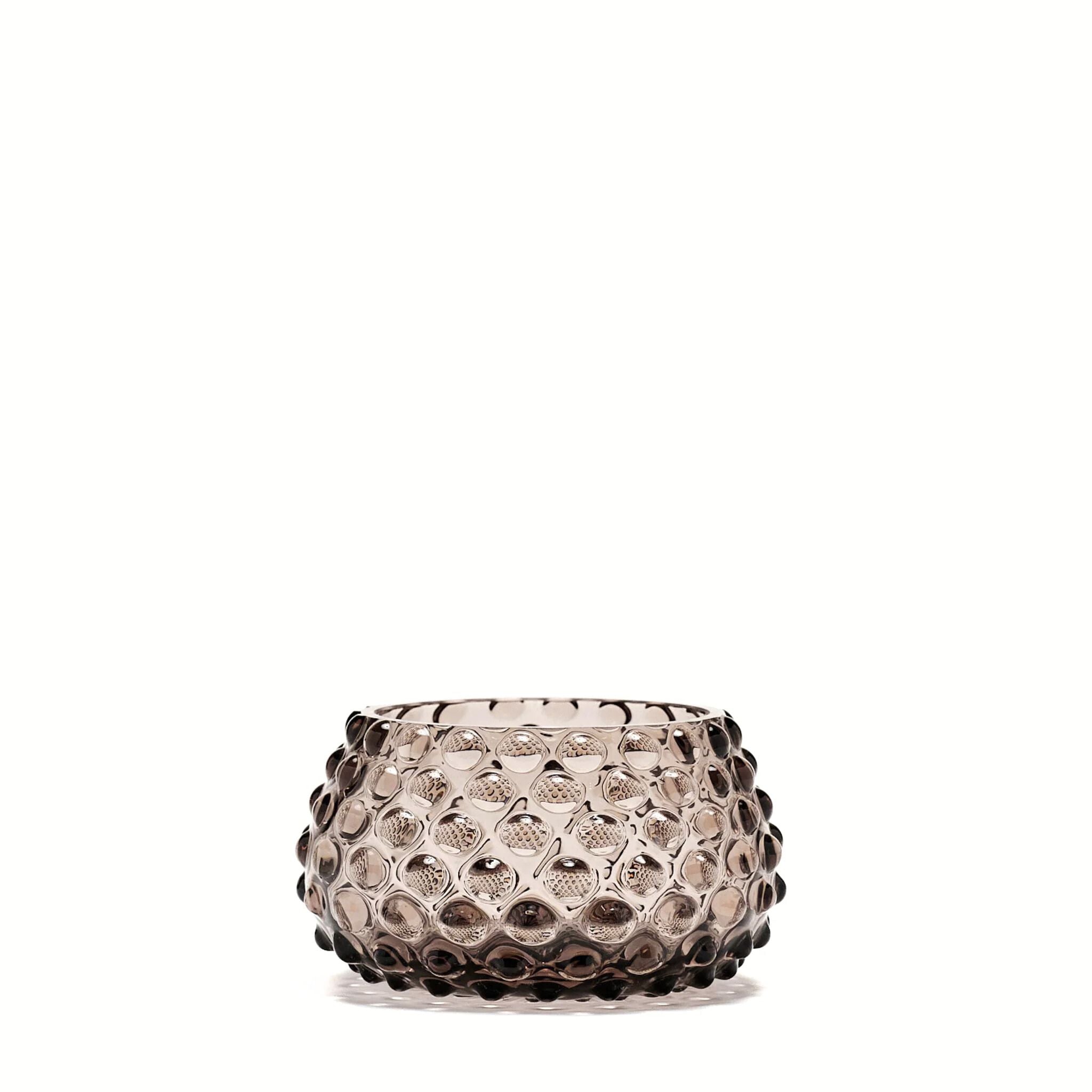 Decorative glass bowl with textured pattern on a white background