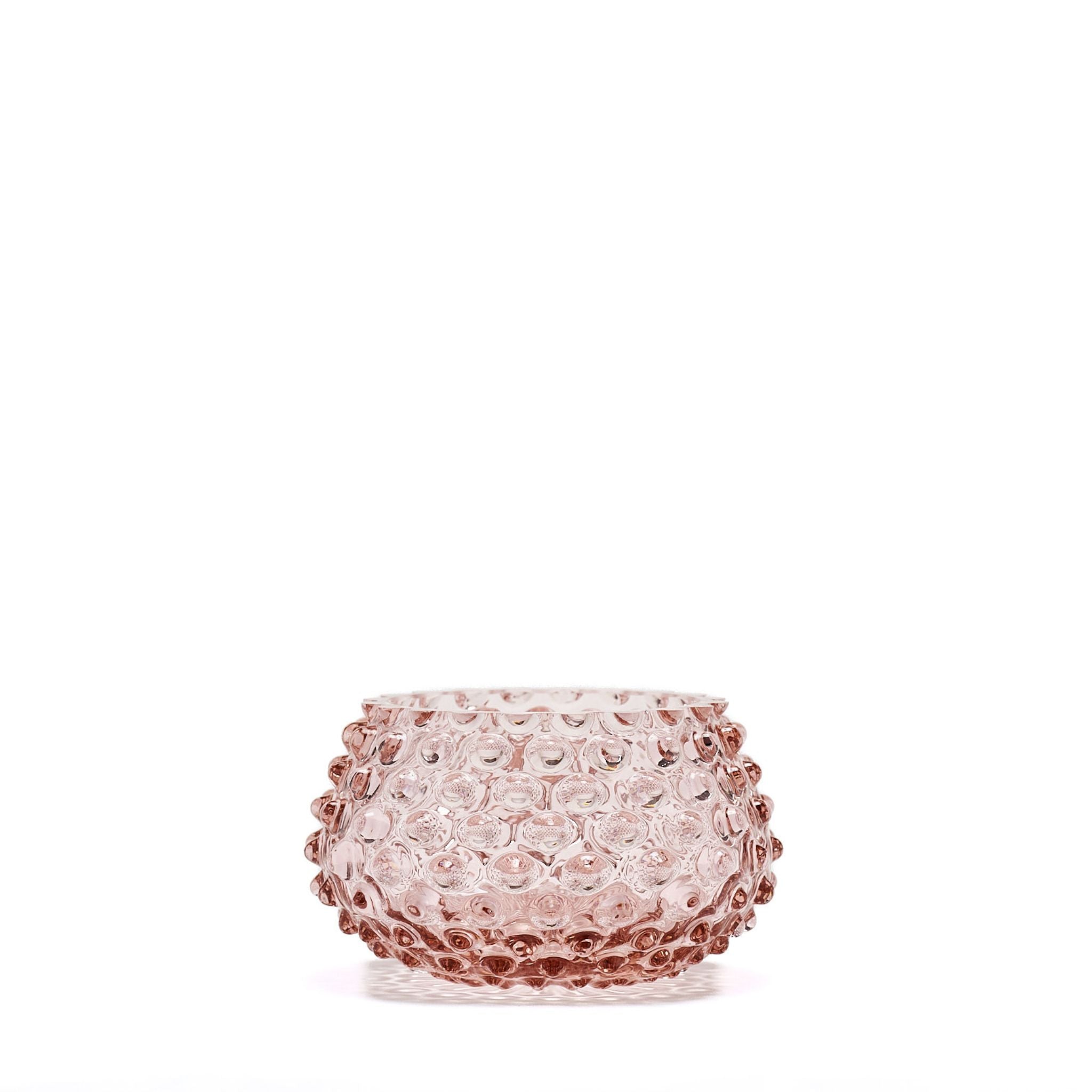 Pink textured glass vase on a white background