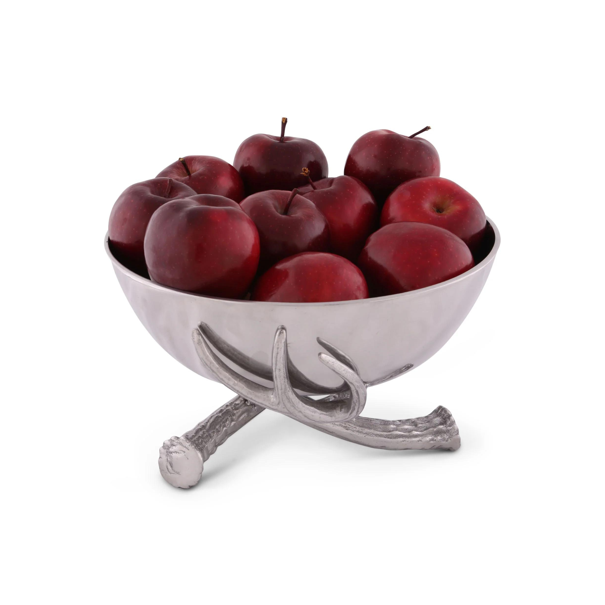 a metal bowl with 3 metal antler base filled with red apples