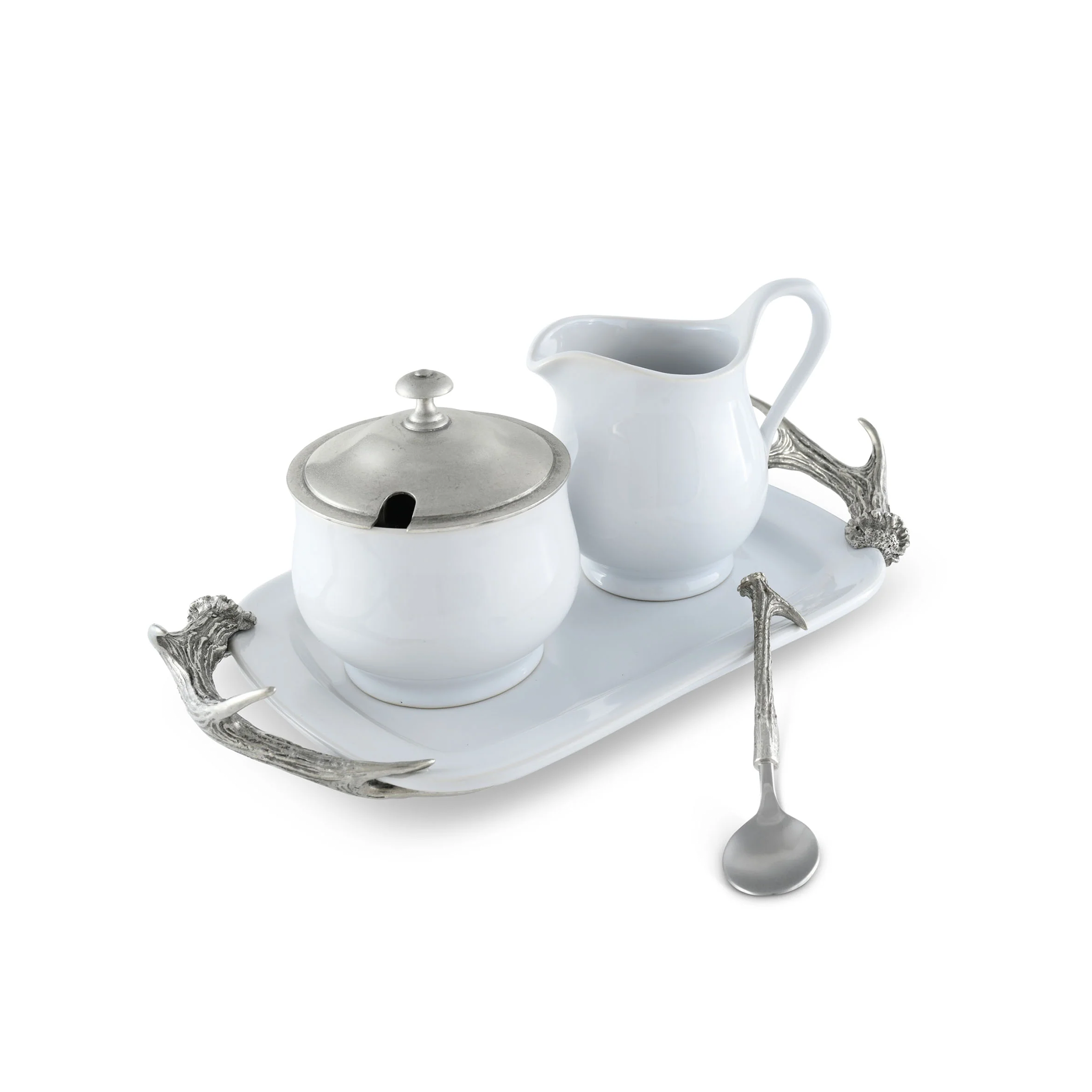 a porcelain and pewter creamer set and tray on a white surface