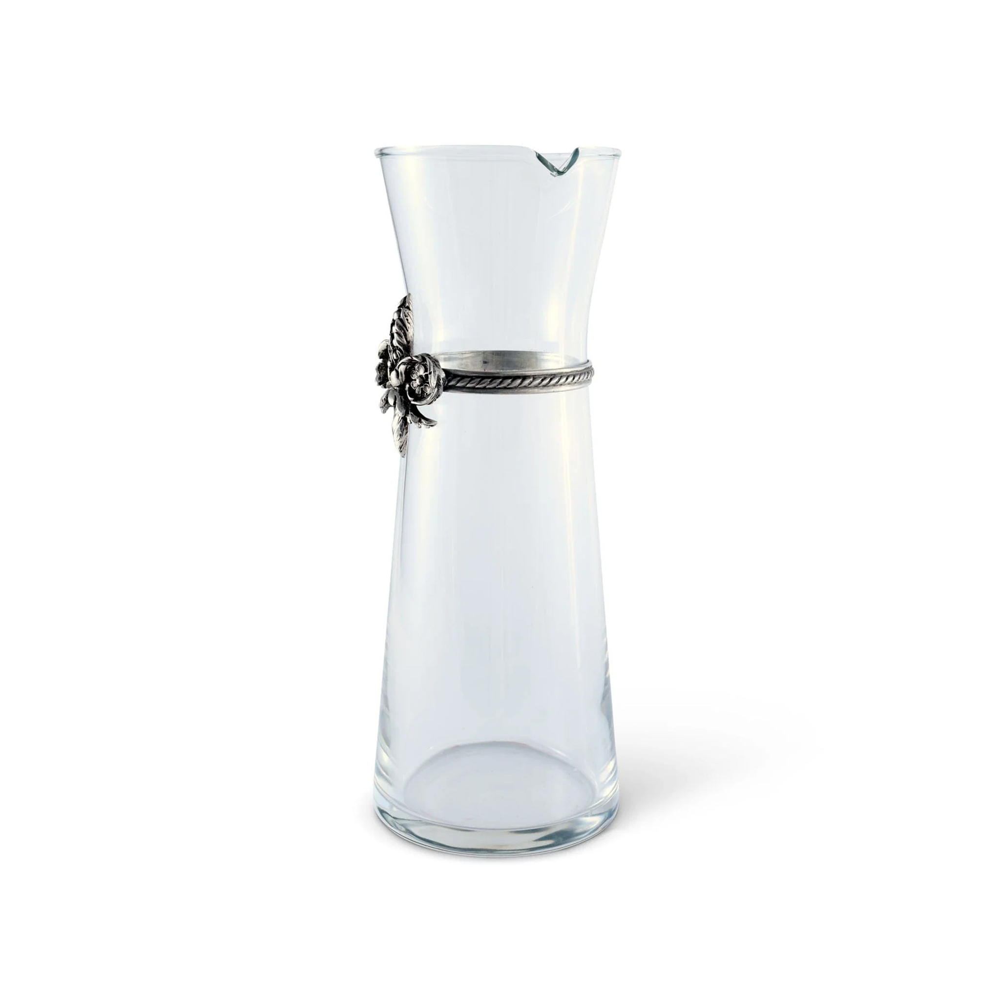 a clear wine carafe with a pewter metal fluer de lis on it