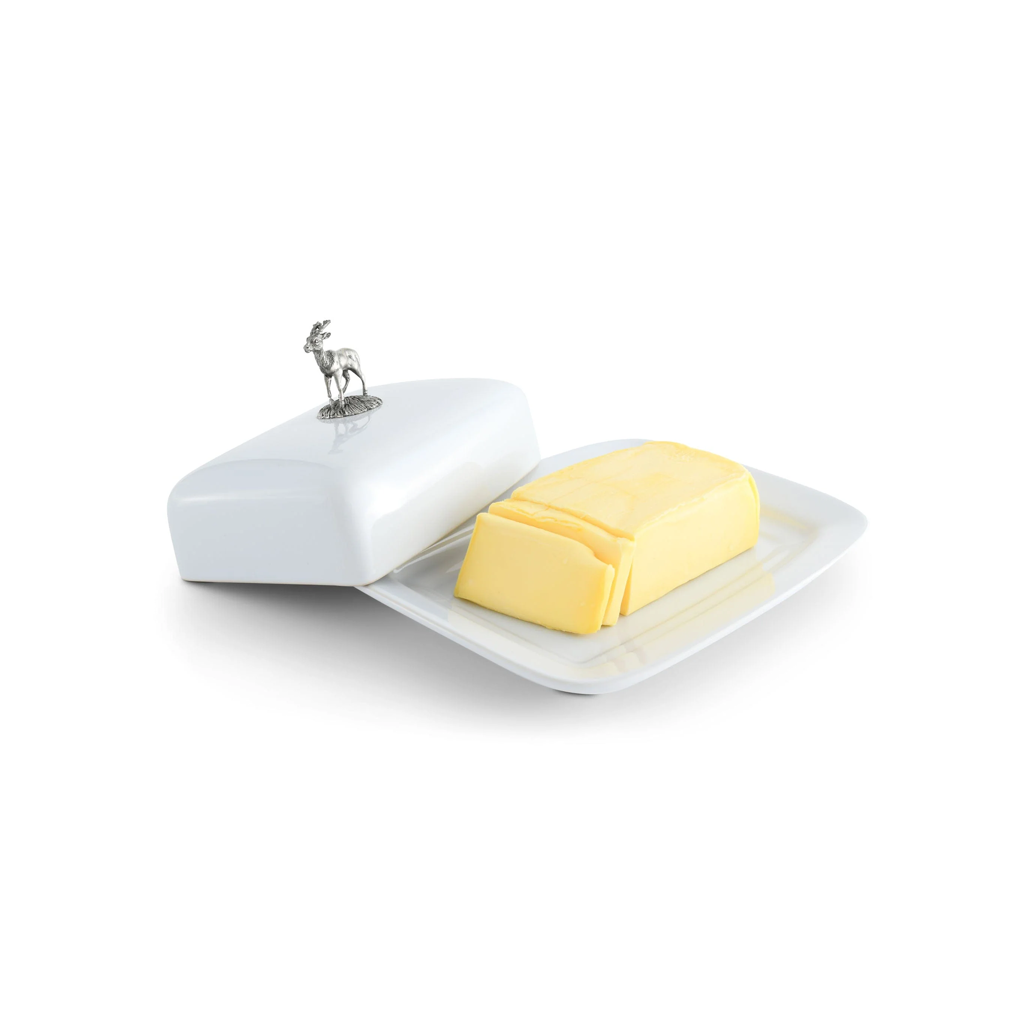 a white butter dish with a pewter stag handle with a piece of butter on it