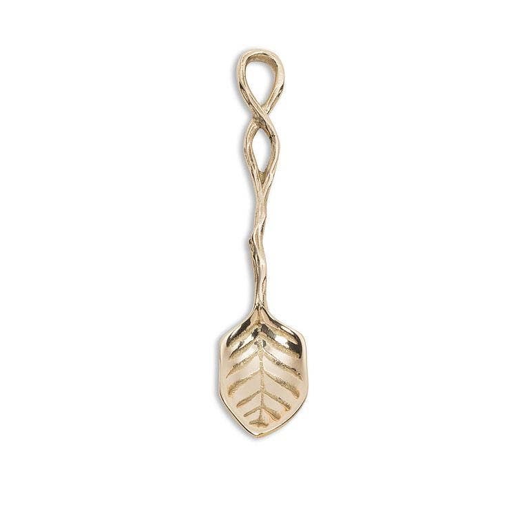 Gold-colored spoon with leaf design on a white background