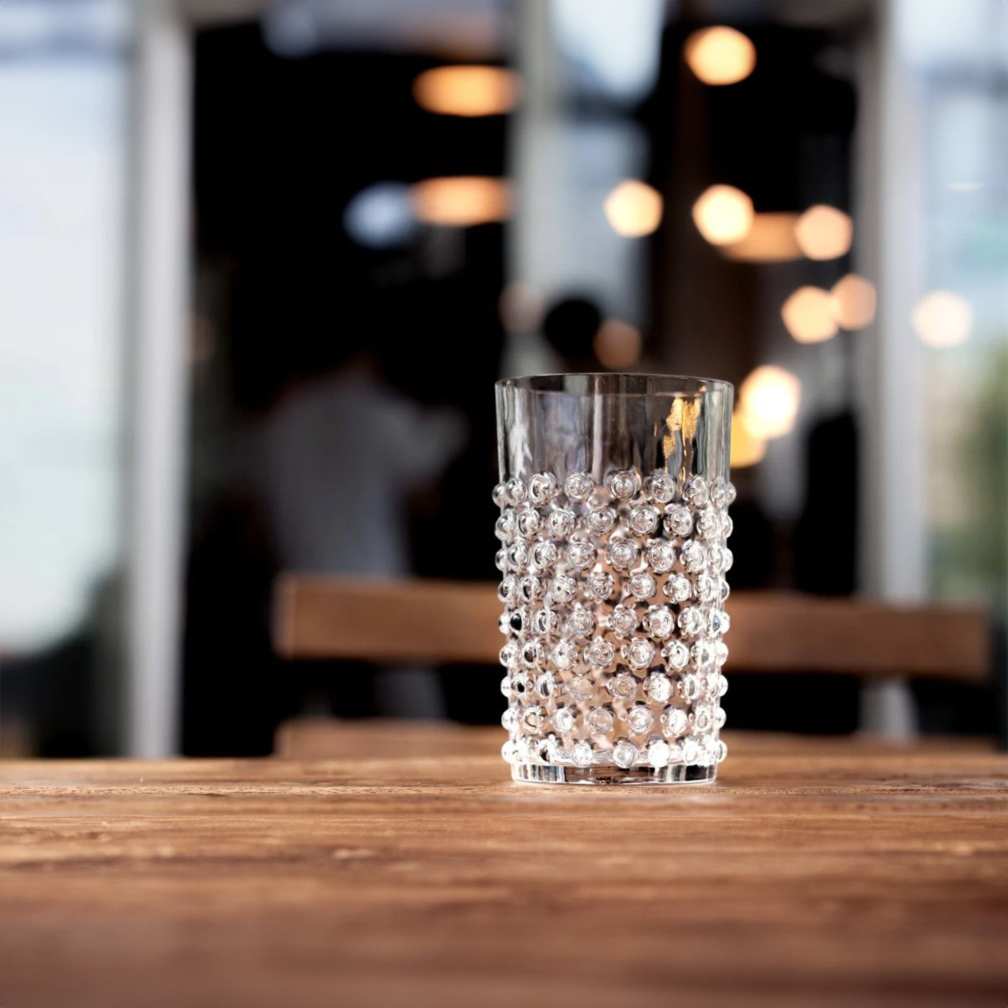 a glass of water sitting on top of a wooden table