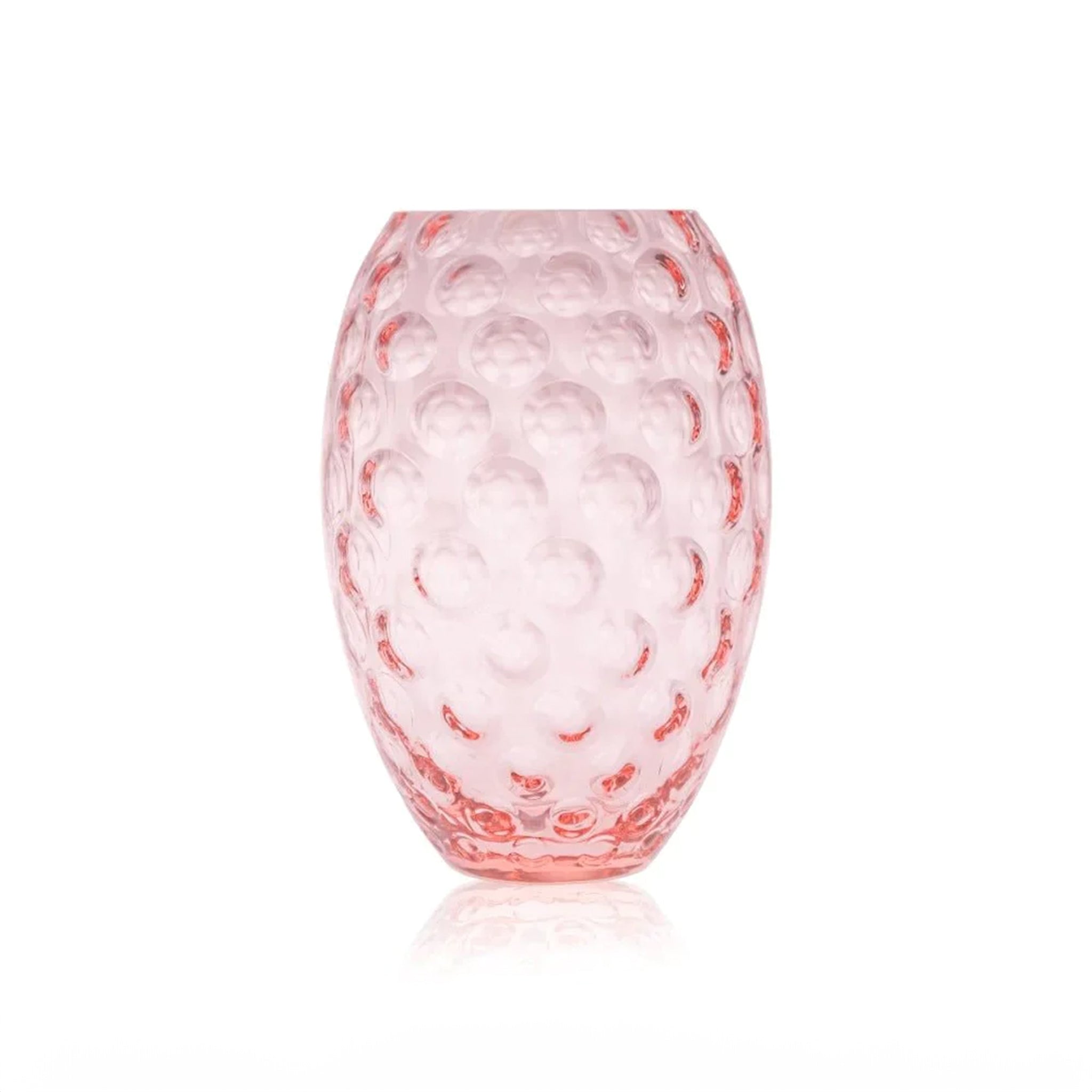 a pink vase sitting on top of a white table