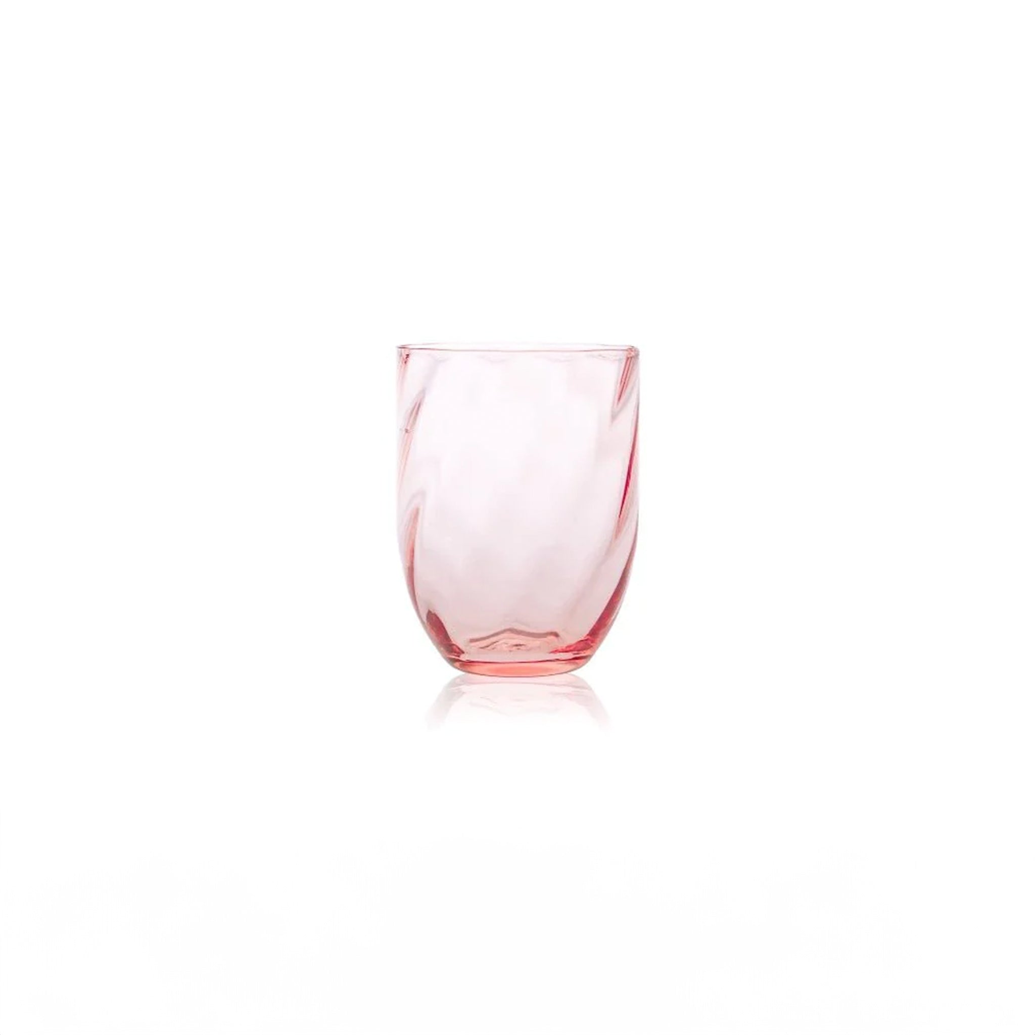 a pink glass sitting on top of a white table