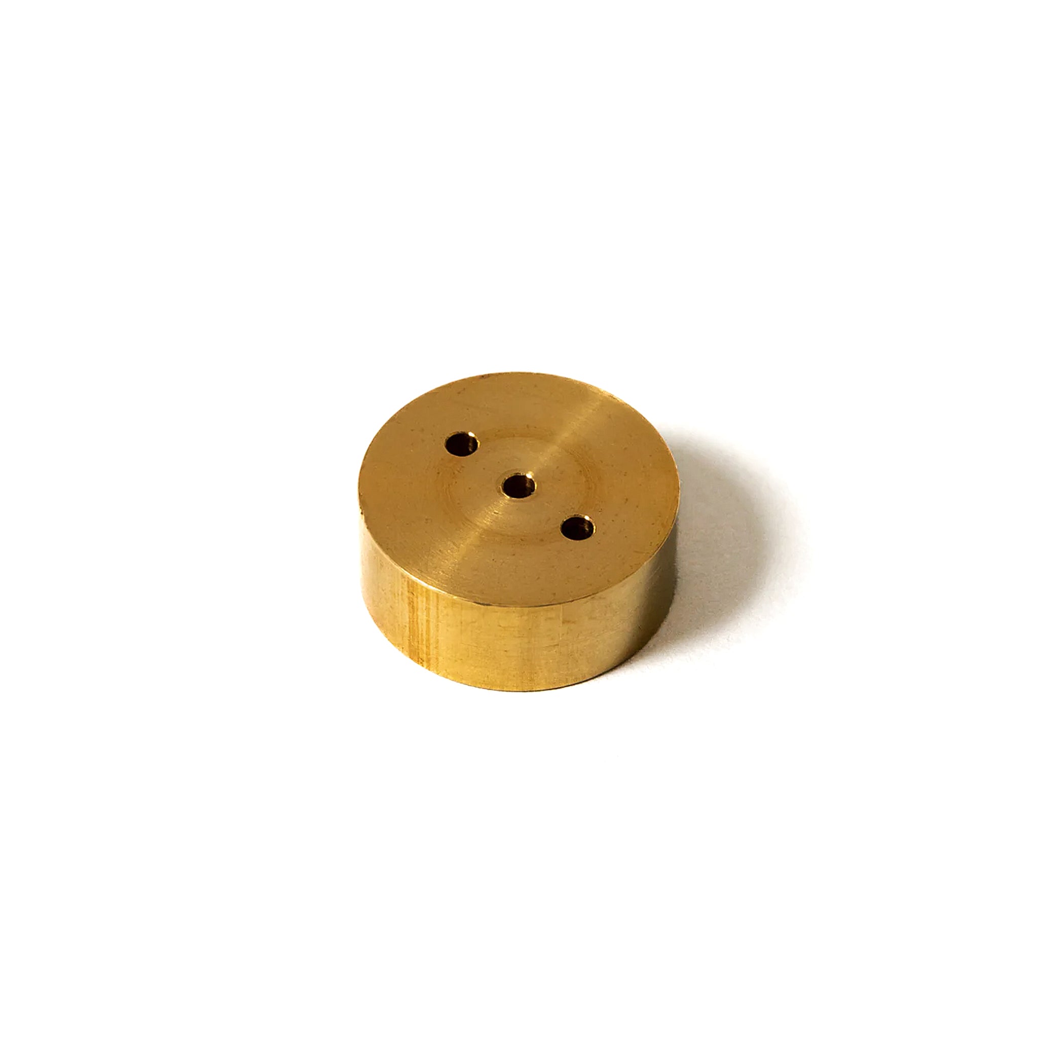 Brass incense holder with three small holes, minimalistic design on a white background.