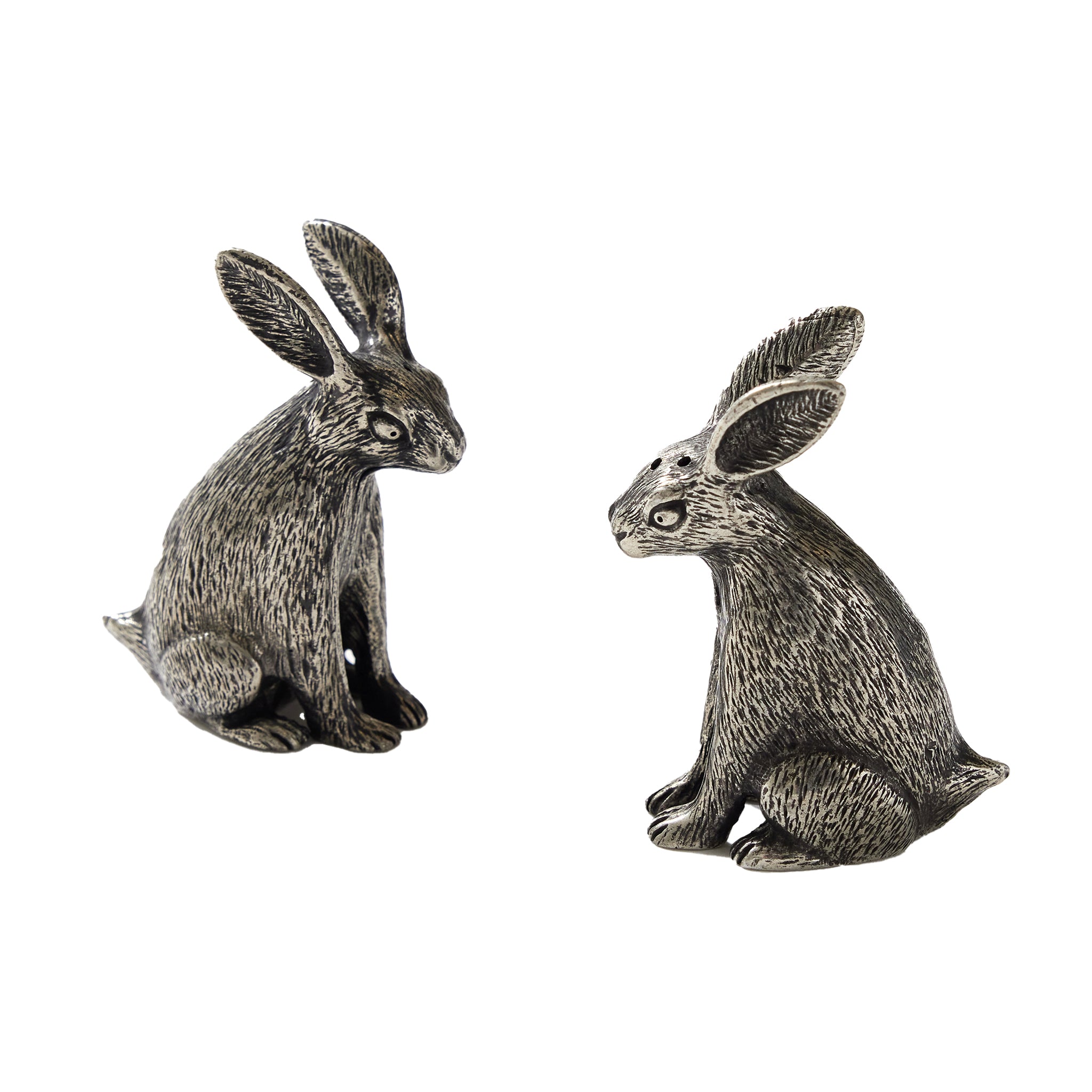 Two pewter salt and pepper shakers designed in the shape of rabbits, with intricate textured details to resemble fur.
