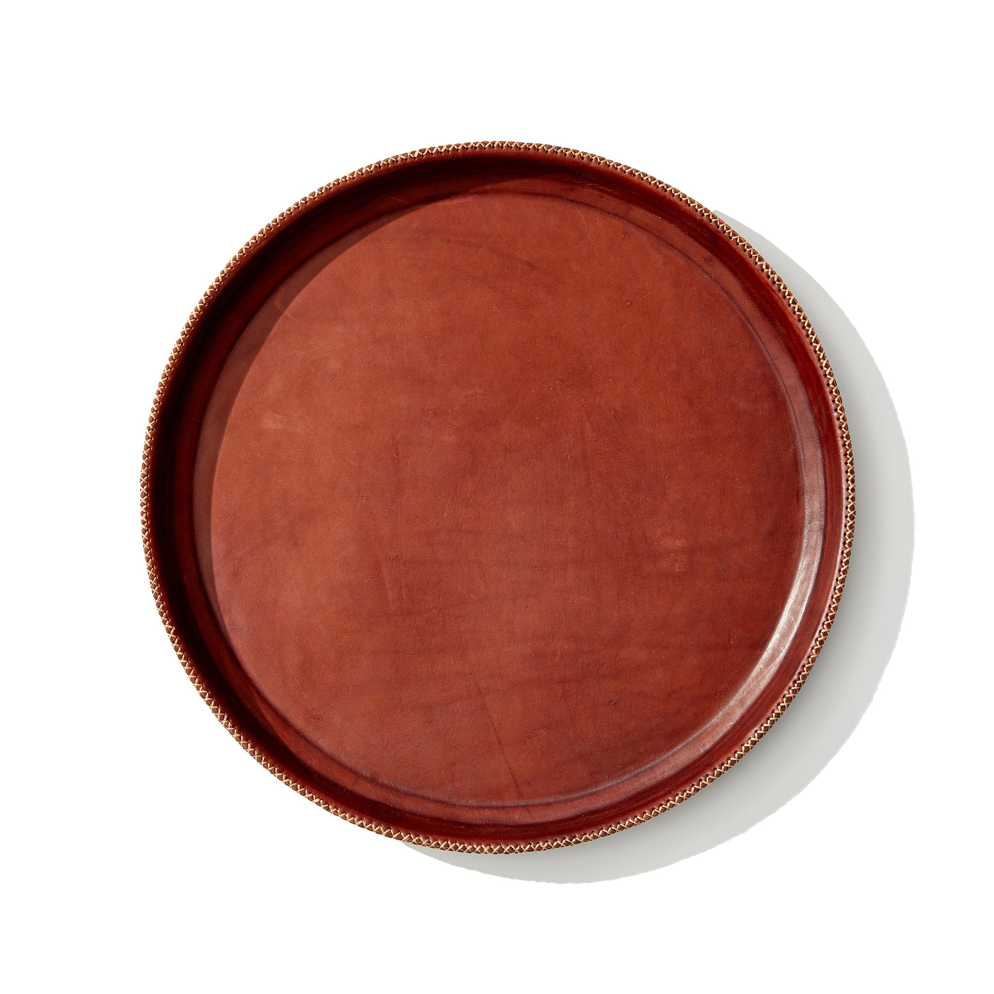 a brown leather serving tray on a white background