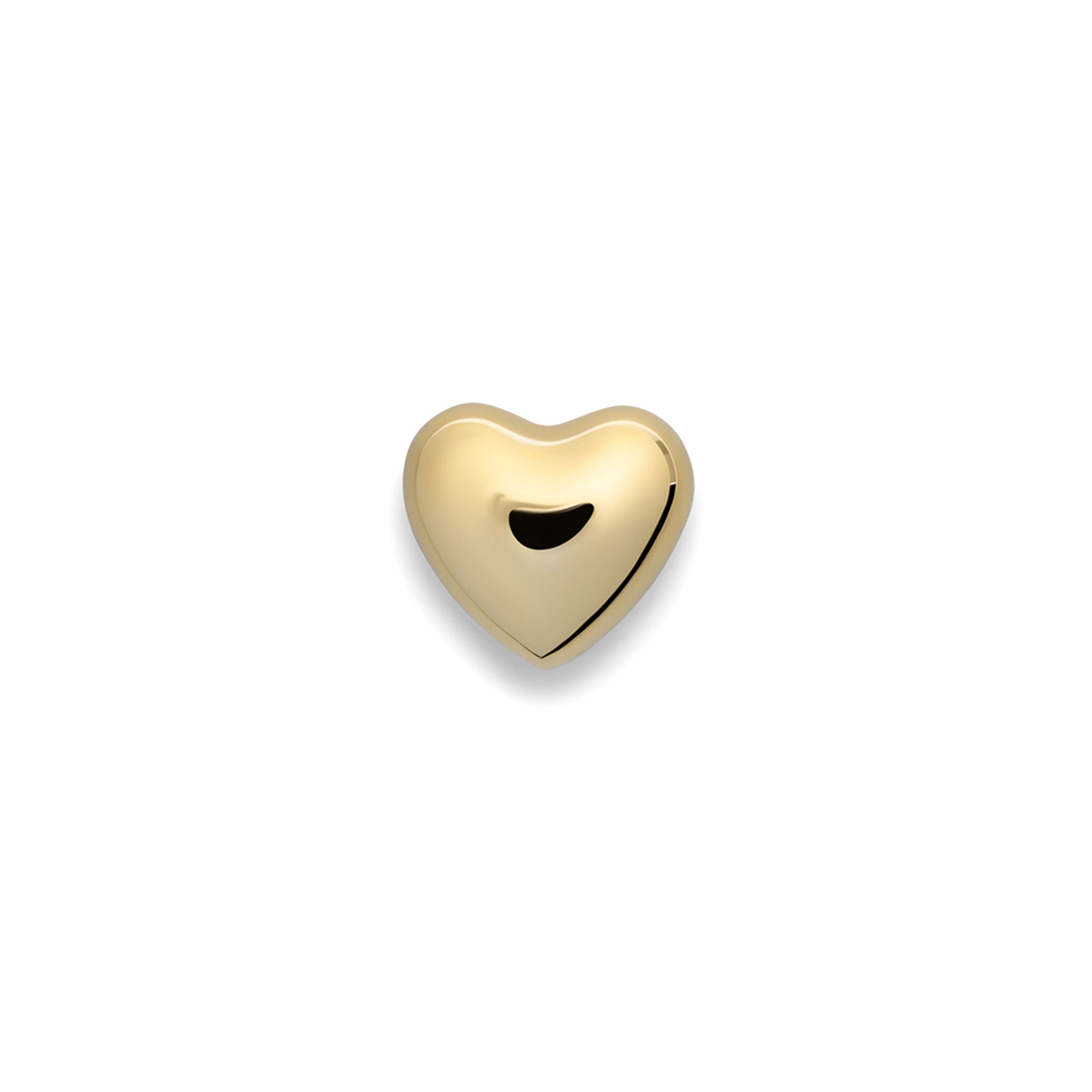 a gold heart shaped paperweight on a white background