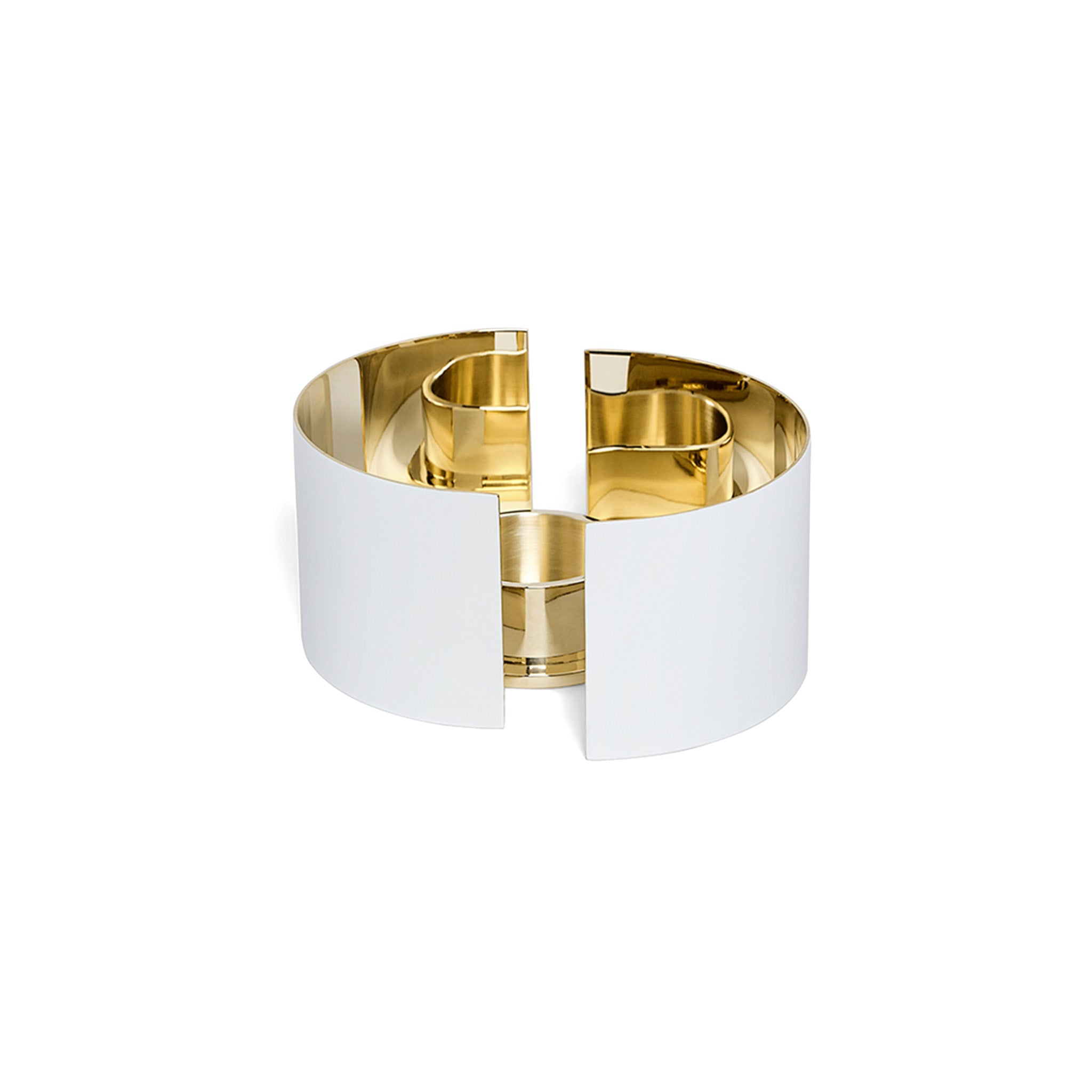 a side view of a white and brass infinity candle holder by skultuna on a white background