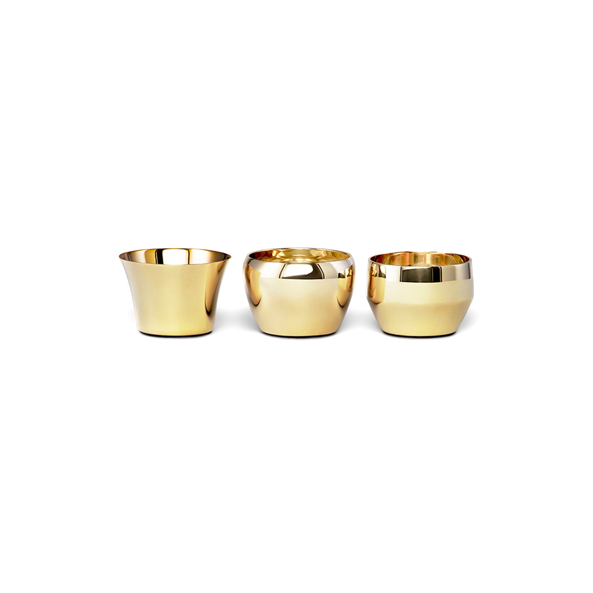 three brass tealights by skultuna sitting next to each other in a side view