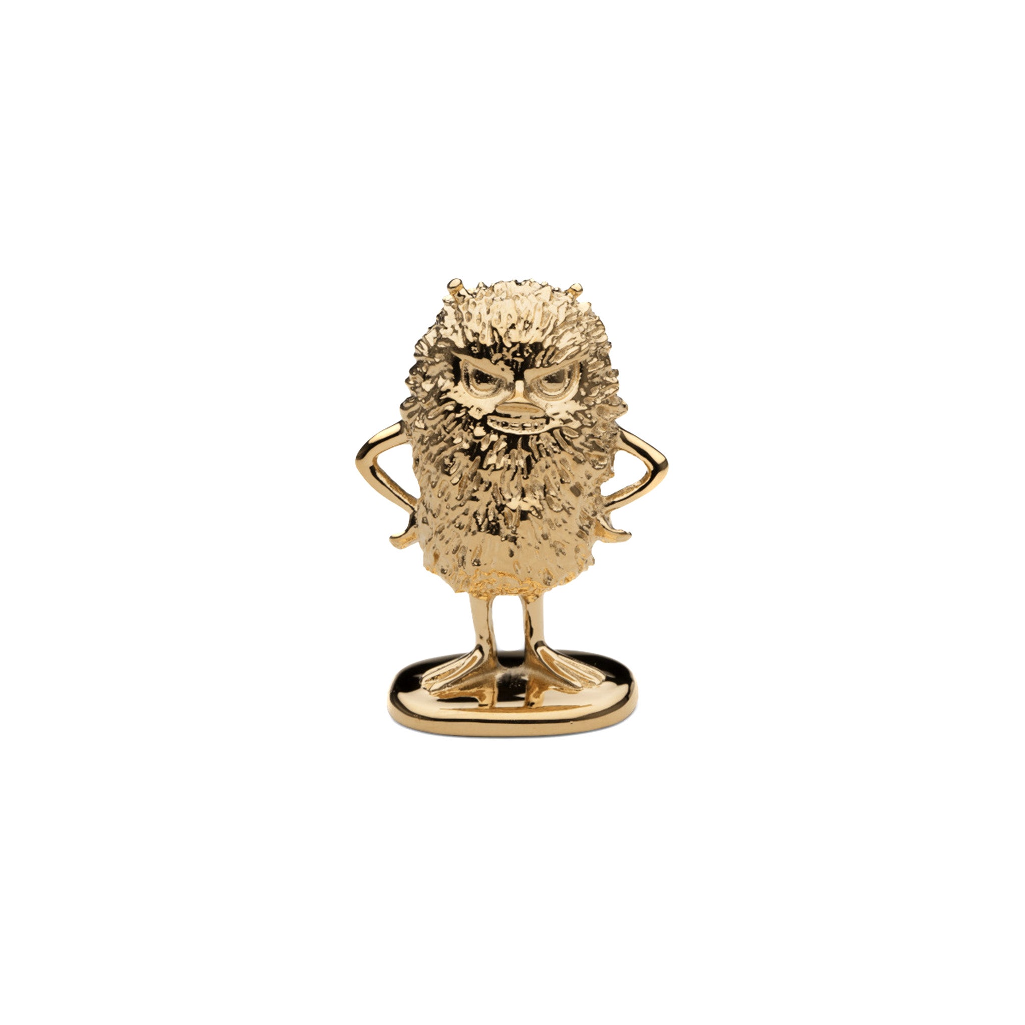 a gold figurine of moomin stinky facing forward on a white background