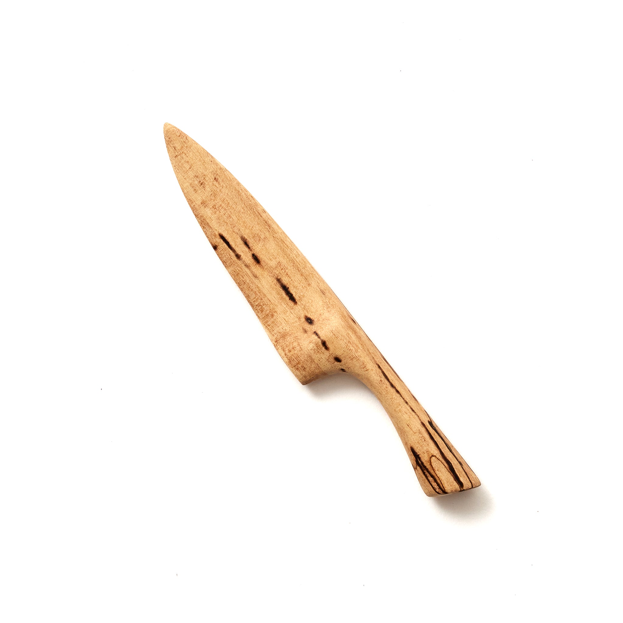 A simple wooden knife with a pointed tip and a handle, featuring dark grain patterns against a lighter wood tone. The knife is centered on a plain white background.