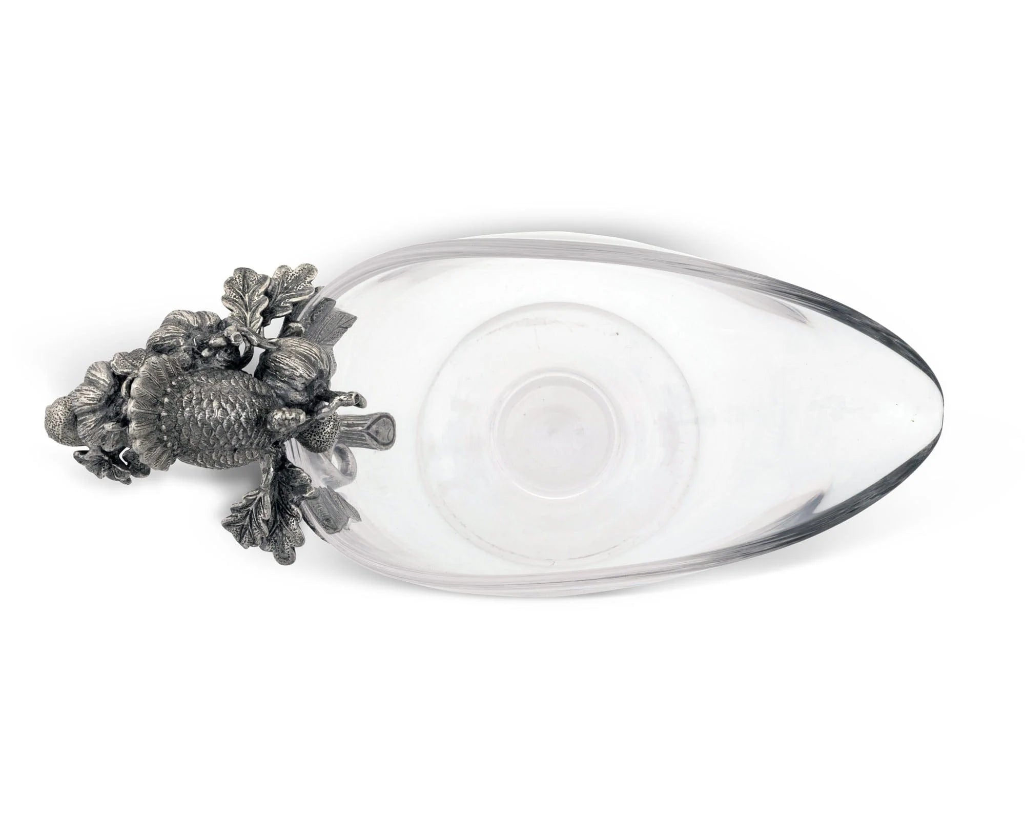 a top down view of a glass gravy boat with pewter handle adorned with noble symbols of autumn's abundance