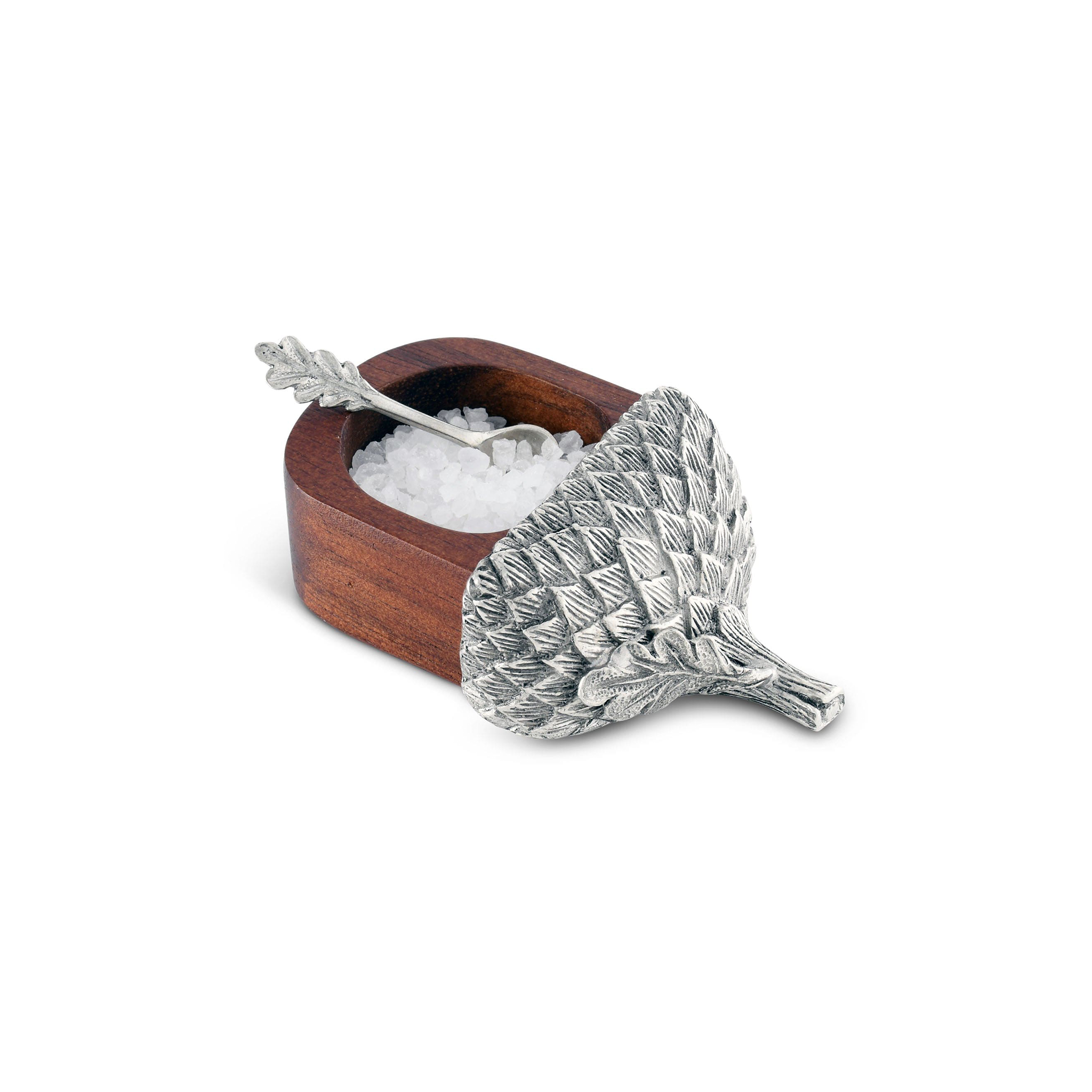 a small wooden acorn salt cellar with salt in it with a pewter cap on it on a white background